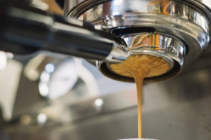 Espresso pours down from the machine