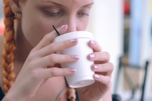 Redhead woman drinking coffee